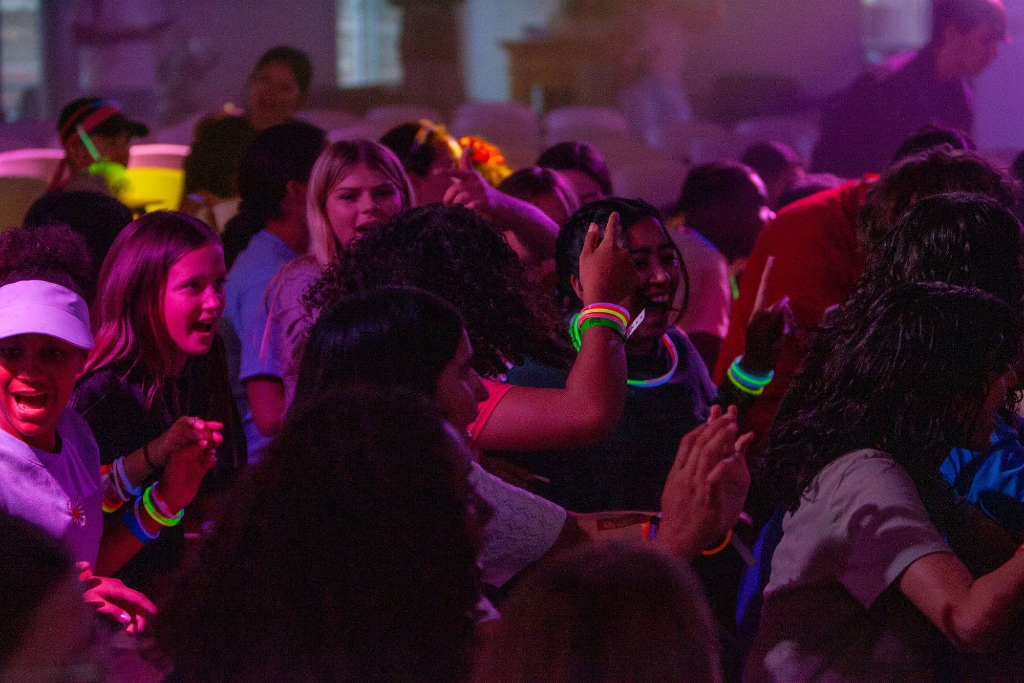 Students with glow sticks at an evening session