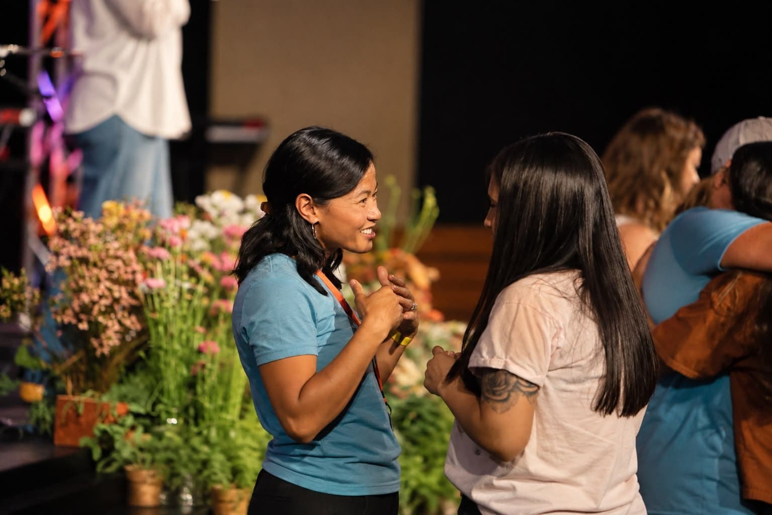 Two women talking and laughing after a service at Canvas Church